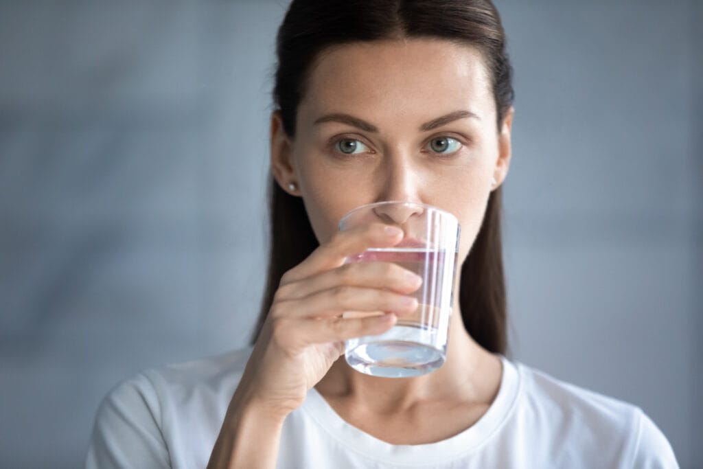 Head Shot Beautiful Woman Drinking Clean Mineral Water, Holding